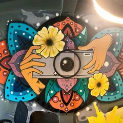 For this photography studio in South Delhi, I created a custom mural blending a camera with intricate mandala and floral designs. This piece is a great example of how I translate a brand's creative identity into a unique visual story.
