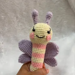This butterfly stick rattle is designed to be easy for babies to hold. It's made in soft pastel colors and has a gentle rattle sound inside.