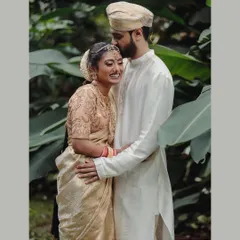A beautiful, tender moment between a couple, framed by the lush greenery of the Taj West End. Their embrace speaks of comfort, love, and a lifetime of happiness ahead.