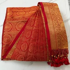 This is where the magic begins. A stunning red and gold bridal Kanjeevaram, with its skirt and pallu pleats crisply pressed and folded. It's boxed and ready for the bride to wear without any last-minute stress.