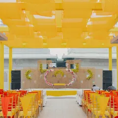 A vibrant and sunny Haldi ceremony setup at the Fairmont Jaipur. The bright yellow drapes and floral arrangements create a joyful and energetic atmosphere, perfect for pre-wedding festivities.