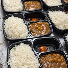 A close up of our popular Jeera Rice and Chole Masala meal boxes. We ensure every meal is packed fresh, hot, and hygienically, perfect for corporate lunches or institutional catering.