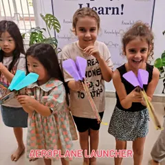 These students are ready to launch their paper airplanes with custom-built rubber band launchers, a fun experiment in kinetic and potential energy.