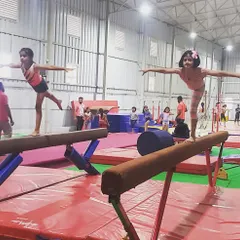 In my classes, students learn focus and discipline while also encouraging each other. Here, two young gymnasts practice their balance and form on the beams during a group session.