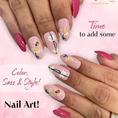 See the detail in our custom nail art. This design features a soft pink base with delicate white daisy art, complete with tiny bees and vibrant magenta accent nails for a cheerful, stylish look.