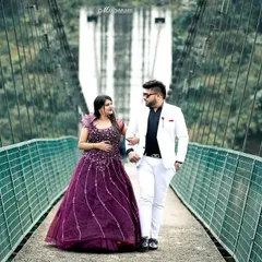 A stylish couple walks across a suspension bridge, surrounded by the lush greenery of the Rishikesh hills. I use these architectural elements to frame your story and add a sense of adventure to your pre-wedding album.