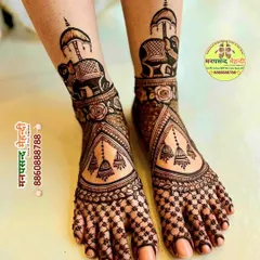 An elegant bridal foot mehndi design featuring decorated elephants and beautiful hanging jhumkis. The intricate net pattern on the toes and the detailed ankle design ensure your feet look just as stunning as your hands.
