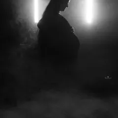 A powerful silhouette created with smoke and dramatic backlighting. This black and white image is all about form and atmosphere, creating a mysterious and beautiful portrait.