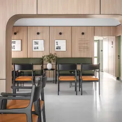 The main waiting hall is organized to provide a sense of personal space while maintaining an open feel. The arrangement of seating encourages quiet reflection before an appointment.