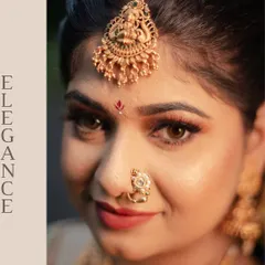 An artistic close-up focusing on the bride's "Elegance." This shot highlights her beautiful eyes, the intricate design of her maang tikka, and her traditional nose ring.