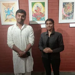It is always a joy to connect with those who engage with my art. Here I am with a visitor at my exhibition, discussing the stories and details behind the paintings. These interactions are a vital part of my artistic life.