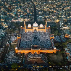 A high-altitude perspective of Jama Masjid, showing the main road leading to the mosque filled with people. This shot emphasizes the sheer volume of attendees and the grandeur of the location during the Eid festival.