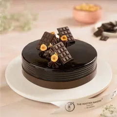 A classic that never goes out of style. Our Chocolate Truffle Cake features layers of moist chocolate sponge and rich, silky ganache, finished with a glossy glaze and chocolate accents.