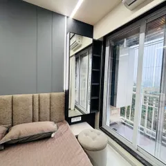 A close-up of the compact dressing area next to the bed, complete with a mirror, shelving, and a small pouf. This is a great example of how I utilize every corner of the room.