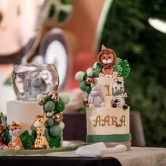 A closer look at the two showstopper cakes from a recent safari-themed birthday party. On the right, a two-tiered cake for the birthday boy 'Aara', and on the left, a complementary cake featuring an adorable elephant centerpiece.