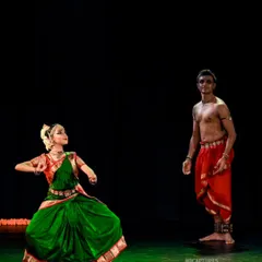 A full-stage view of 'SUTÃ', showing the dynamic between the two performers. The contrast in our costumes and postures tells a story of connection and guidance.
