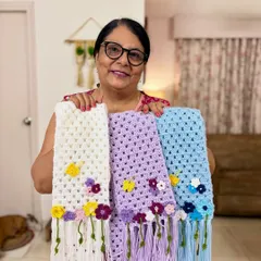 I love seeing my crochet flower scarves together. Each one, whether in white, lavender, or blue, is made with immense patience and attention to detail. The little flowers and tassels add a touch of handmade charm.