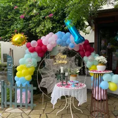 Another view of the cafe birthday decoration, showing the full setup with the cake tables.