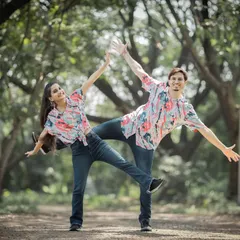 A perfectly synchronized, playful pose in a park. This kind of fun and quirky shot is a great way to showcase your personalities.