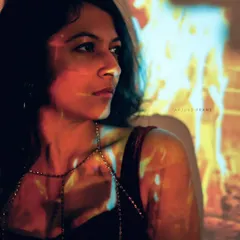 A colorful portrait from the 'Quismois' series. The warm, fire-like projection on my face and body creates a dramatic and painterly effect for conceptual art.