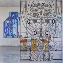 This intricate metal screen serves as a partition, dividing a space while maintaining a sense of openness. The detailed, linear design is inspired by ancient art forms, reimagined to create a modern totem that separates and connects simultaneously.