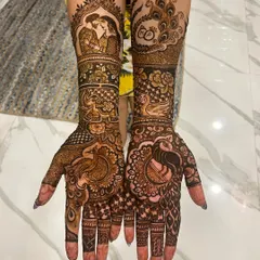Your mehendi can be your love story. For this bride, I wove in portraits, wedding rings, and beautiful peacocks, creating a full bridal design that was deeply personal and traditional.