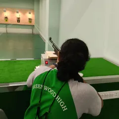 A student from Greenwood High focuses on her target. Our school programs are designed to be holistic, combining live shooting with exercises that improve balance, concentration, and mental calm.