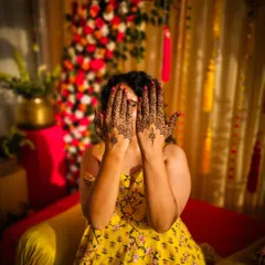 A playful peek-a-boo pose with minimalist henna, showing the delicate patterns on the back of the hands.