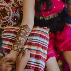 Here you can see the process of creating a traditional armband, featuring a kalash and intricate filler patterns. Each element is drawn with a steady hand.