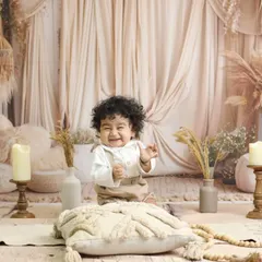 A beautiful, candid smile from this little boy enjoying our rustic studio setup. We use a variety of textures and props to add depth and interest to these timeless portraits.