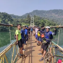 A group of happy riders on a suspension footbridge over the Kali river. This is a highlight of our Dandeli tour, taking you deep into the wild country of the Kali Tiger Reserve.