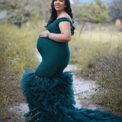 Standing strong and glowing with love in an outdoor setting. This portrait in a deep green ruffled gown shows that elegance can be found anywhere, from the studio to nature.
