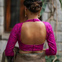 A bold and beautiful design, this magenta blouse features a deep, open back and full-length sleeves for a dramatic and elegant look.