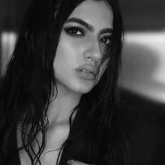 A powerful black and white portrait of Kashika Kapoor. The intense, kohl-rimmed smokey eye and wet, slicked-back hair create a dramatic and captivating look that is both timeless and modern.