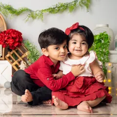 The bond between siblings is so special. We focus on creating a comfortable space where their natural affection shines through, capturing sweet moments of connection like this gentle hug between a big brother and his baby sister.