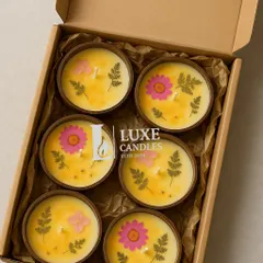 A box of six coconut shell candles, decorated with real dried flowers. This is a whole vibe, perfect for boho home decor or aesthetic wedding favors.
