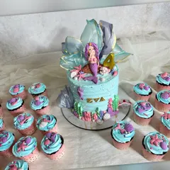 For this mermaid-themed party, I created a complete underwater world. The main cake features a custom mermaid figure and delicate sugar work, surrounded by matching chocolate mint cupcakes topped with little shells and starfish.