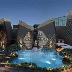 The butterfly-inspired clubhouse at Kohinoor Uptown in Kalyan is the centerpiece of the community. This night view highlights the dramatic architecture and the inviting poolside ambiance we designed for residents to enjoy.