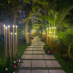 An evening event pathway illuminated with beautiful lights and floral arrangements. We love creating magical walkways that lead your guests into the heart of the celebration.