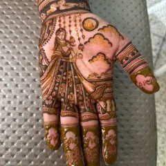 A classic Karwa Chauth design, featuring a woman with a diya, looking at the moon through a sieve.