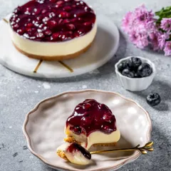 A slice of decadent blueberry cheesecake, captured for Ferns N Petals Luxe. This dessert photography focuses on the creamy texture and the glistening fruit topping, creating a premium and indulgent visual for their bakery catalog.