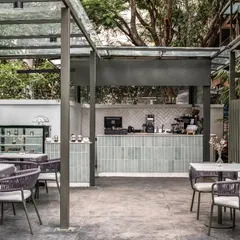 A wider view of the coffee bar and dessert display at Kana Cafe. The open design and consistent material palette make the space feel unified and inviting, encouraging interaction and community.