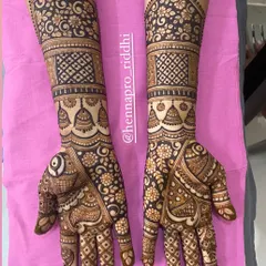 A beautiful three-fourths hand mehndi design. This style provides extensive coverage with detailed floral patterns, checkered fills, and traditional bell motifs, perfect for a bride or her family.