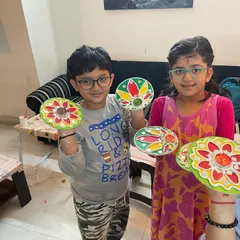 Look at these proud little artists with their handmade Diwali decorations! We used Lippan art techniques to create these colorful tea light holders, perfect for the festival of lights.