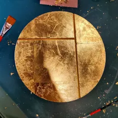 We believe in adding a personal touch to our spaces. These circular wall art pieces were designed and crafted in our own studio for a client's home. Made with wood, vegetable dyes, and gold and silver leaf, they represent the phases of the moon and add a layer of bespoke artistry to the interior.