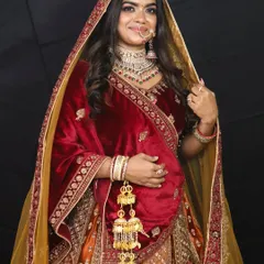 A full view of the magnificent Rajwadi bridal lehenga, complete with a contrasting yellow dupatta. The velvet blouse and intricate skirt embroidery are fit for a queen.