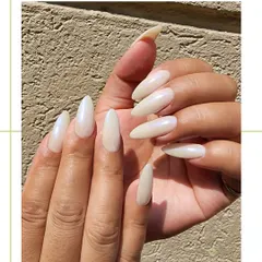 Another shot of the pearl white nails, showing their clean shape and sophisticated shimmer. This is a timeless look that is perfect for any occasion, from daily wear to weddings.