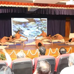 The audience watches intently as our students perform a synchronized forward bend during our anniversary event. These celebrations are a showcase of our students' dedication.
