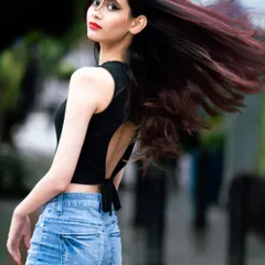 A close-up of the same street style look, focusing on the hair flip and confident glance back. It’s all about capturing that perfect, energetic moment.