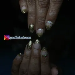 This shot, taken in lower light, shows how the gold glitter and rhinestones catch the light, ensuring your hands look stunning even in the evening.